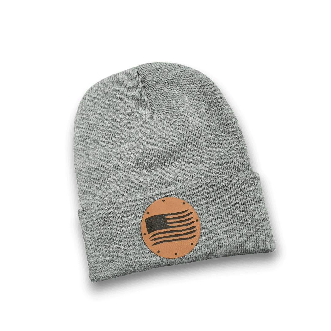 Light grey distressed knit beanie with round tan American flag patch front