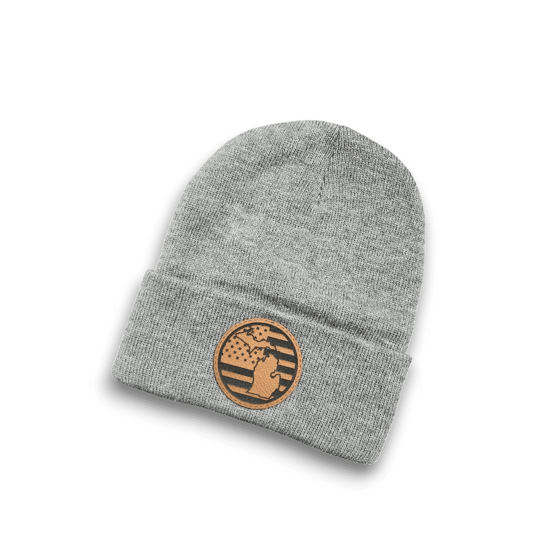 Dark heather grey knit beanie with circular tan Michigan patch on front