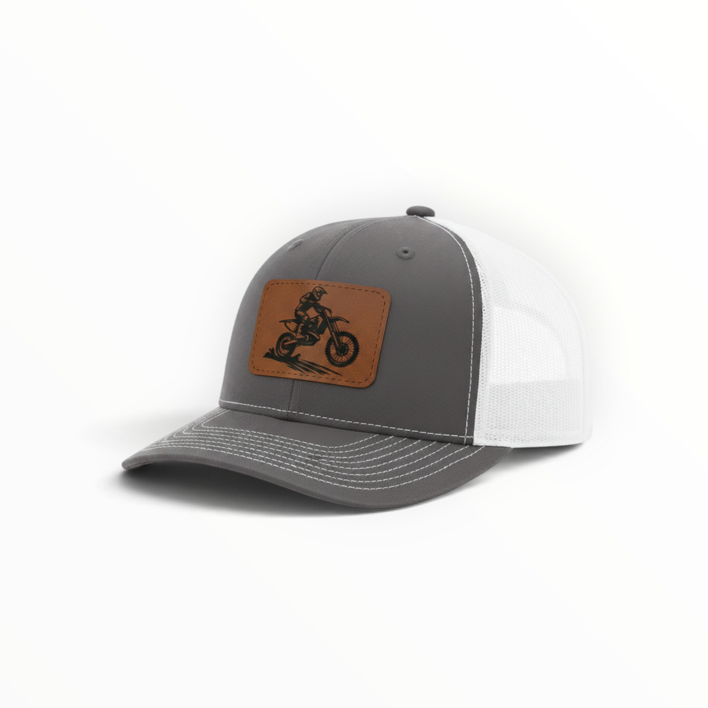Gray trucker hat with tan dirt bike patch and white mesh side panels.