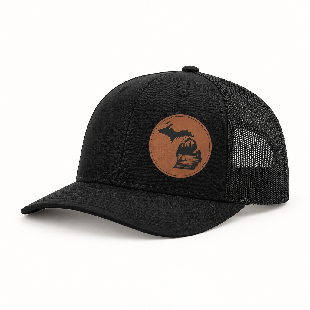 Black trucker hat with tan fishing patch and black mesh back, front view