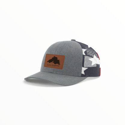 Gray trucker hat with Lake Superior patch and patterned black-white mesh back