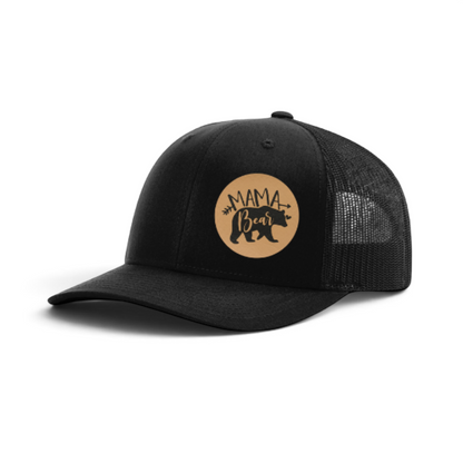 Black trucker hat with round tan Mama Bear patch and black mesh back.