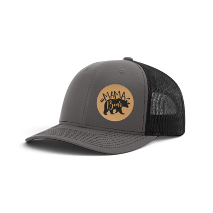 Gray trucker hat with round tan Mama Bear patch and black mesh back.