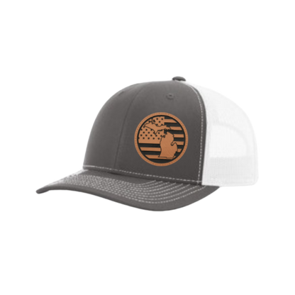 Dark gray trucker hat with circular Michigan patch and white mesh side panel
