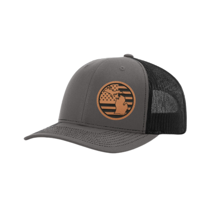 Dark gray trucker hat with circular Michigan patch and black mesh side back panel