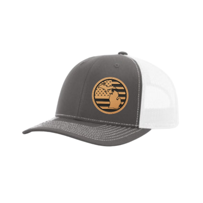 Dark gray trucker hat with circular Michigan patch and white mesh back panel