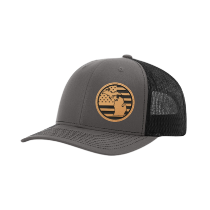 Dark gray trucker hat with circular Michigan patch and black mesh back panel