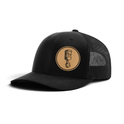 Trucker hat with angry piston patch, black front and black mesh back panels.