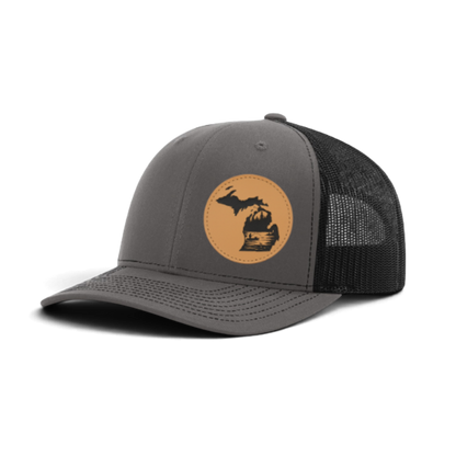 Dark gray trucker cap with black mesh and tan fishing patch