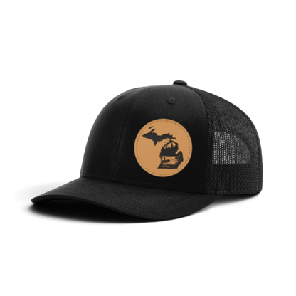 Black trucker cap with black mesh and tan fishing patch