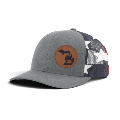 Gray trucker hat with circular fish patch; black mesh side panels with white star pattern