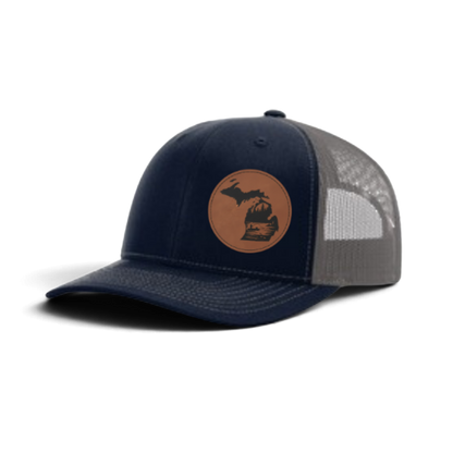 Navy trucker hat with circular fish patch; gray mesh side panels
