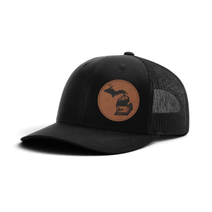 Black trucker hat with circular fish patch; black mesh side panels