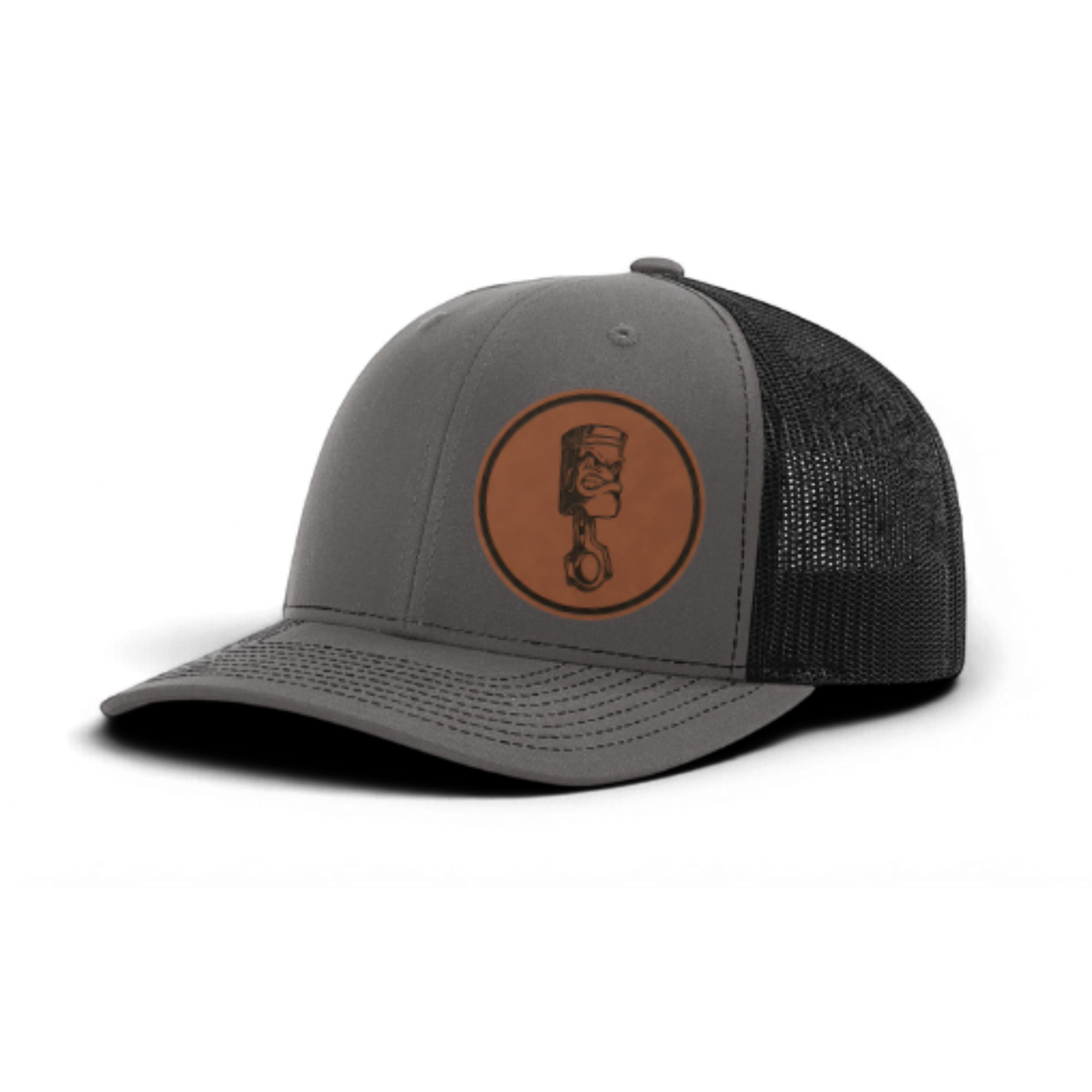 Gray trucker cap with circular piston patch and black textured mesh panel