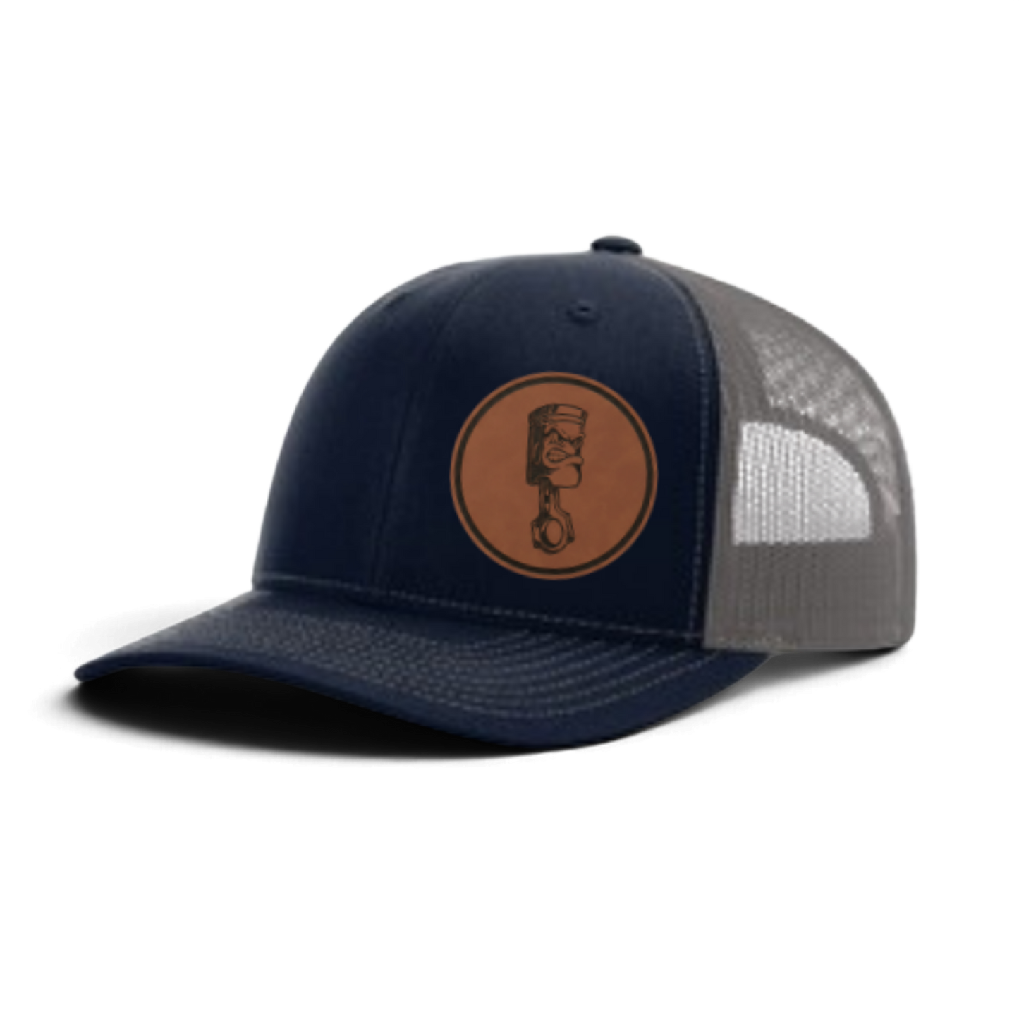 Navy trucker cap with circular piston patch and gray-and-white textured mesh