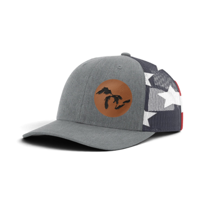 Heather gray trucker hat with tan patch and black silhouette; dark patterned mesh back