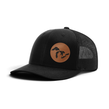 Black trucker cap with round Michigan silhouette patch on front and mesh back