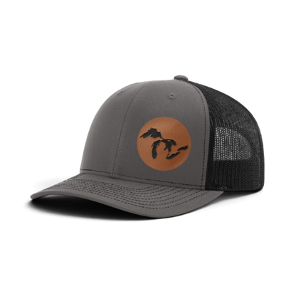 Heather gray trucker hat with tan patch and black silhouette; dark gray mesh back