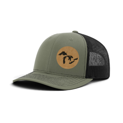 Olive green trucker hat with tan patch and black silhouette; dark gray mesh back