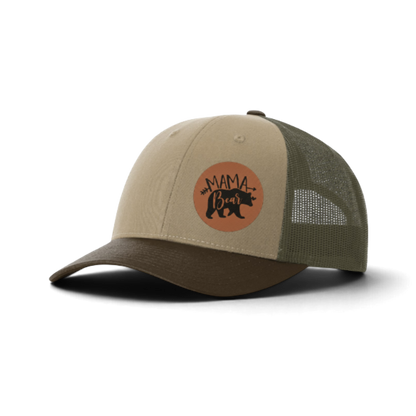 Tan trucker hat with dark green mesh and brown “MAMA Bear” patch.