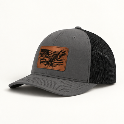 Grey trucker hat with eagle American flag patch and black mesh side panels