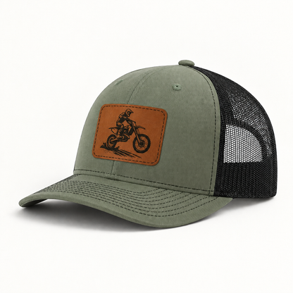 Olive green trucker hat with brown dirt bike patch and black mesh side panels