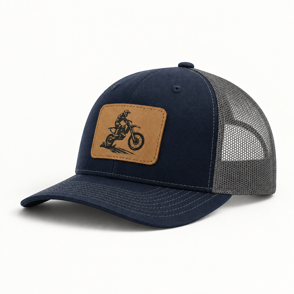 Navy trucker hat with tan dirt bike patch and gray mesh side panels