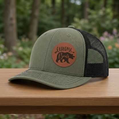 Olive trucker cap with circular Grandma Bear patch and black mesh back