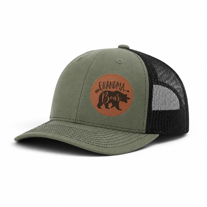 Olive green trucker hat with Grandma Bear round patch and black mesh side panels