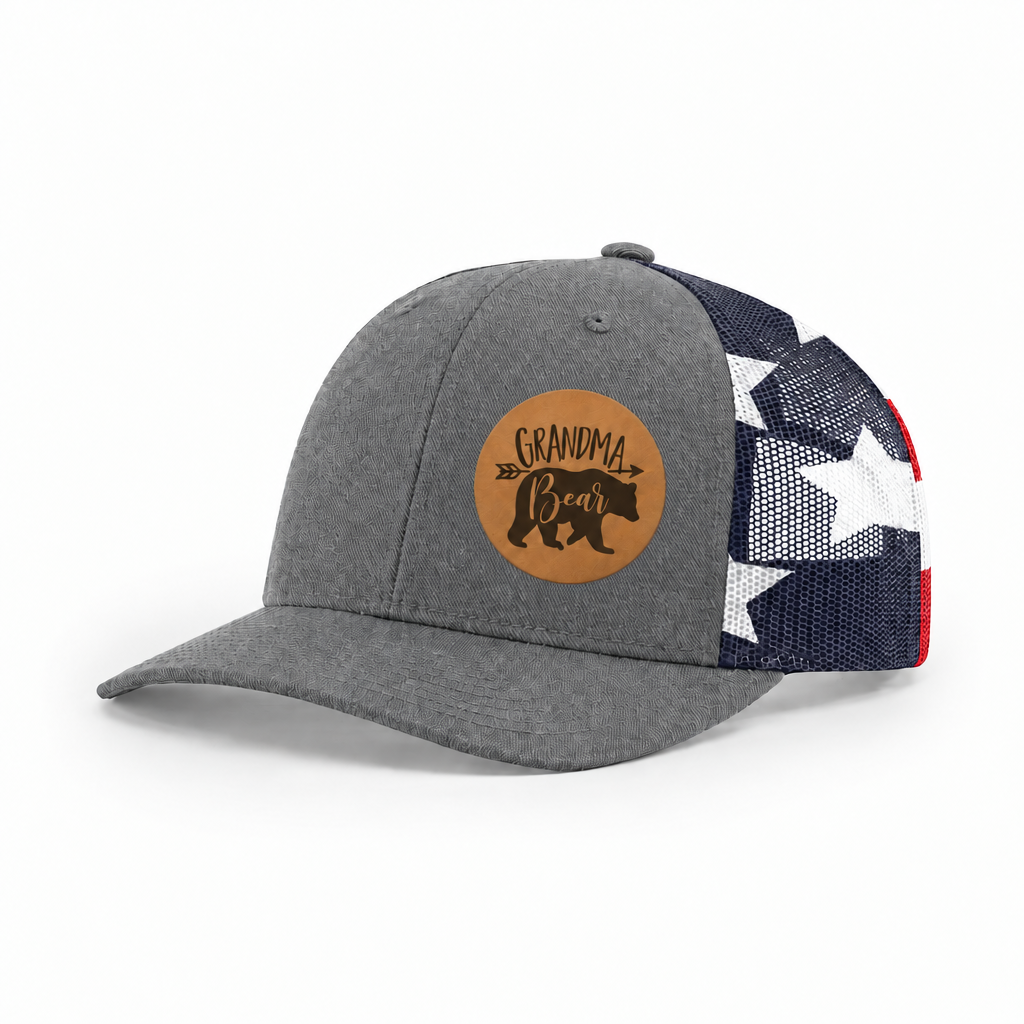 Gray trucker hat with Grandma Bear round patch and navy/white mesh side panels