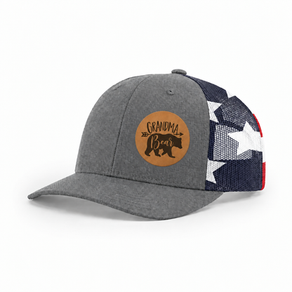 Gray trucker hat with Grandma Bear round patch and navy/white mesh side panels