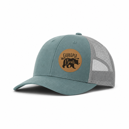 Teal trucker hat with tan mesh side panels and Grandma Bear patch.