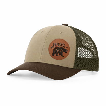 Tan trucker hat with dark green mesh sides and Grandma Bear patch, front view.