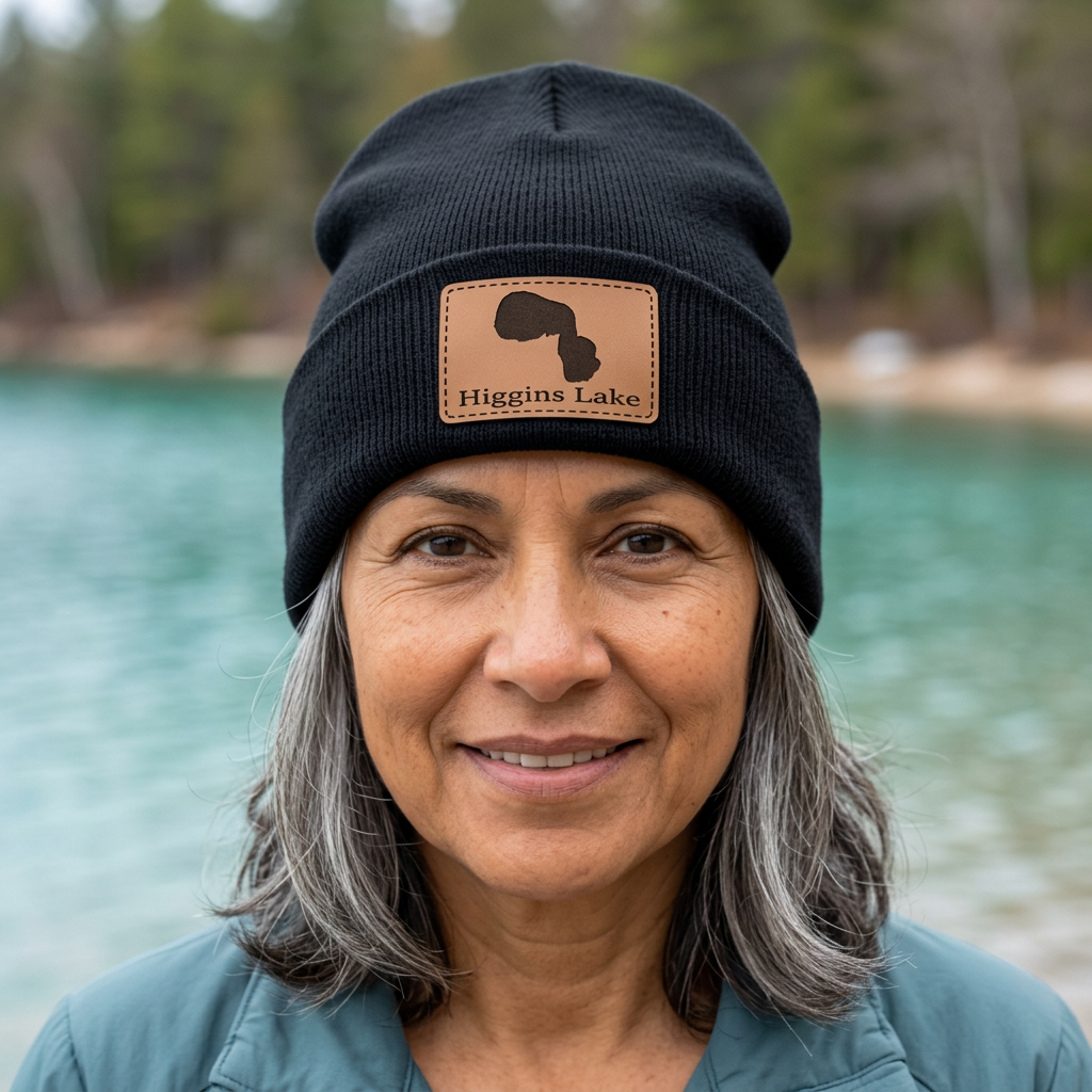 Dark beanie hat with leather patch showing Higgins Lake logo