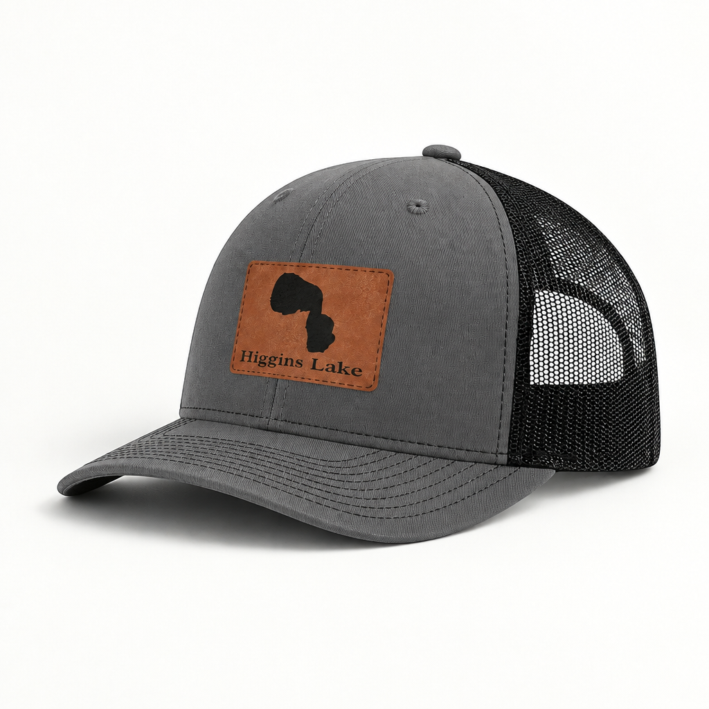 Trucker hat with tan patch, gray front and black mesh back, curved brim