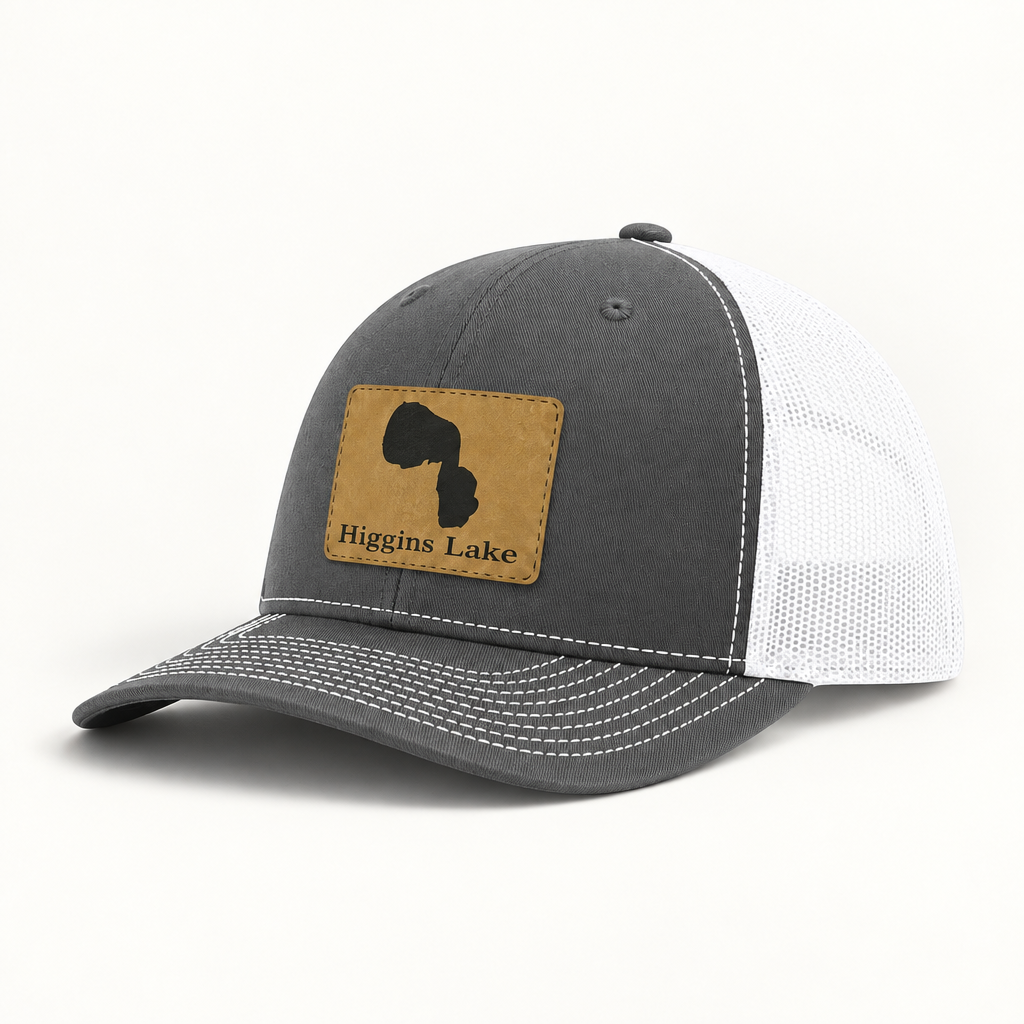 Trucker hat with tan patch, dark gray front and white mesh back, curved brim