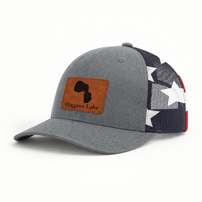 Trucker hat with tan patch, gray front and black mesh star panel, curved brim