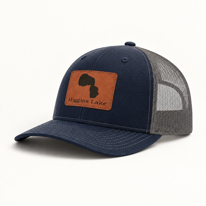 Trucker hat with tan patch, dark blue front and gray mesh back, curved brim