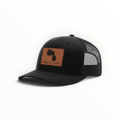 Trucker hat with brown Higgins Lake patch, black front and black mesh back.