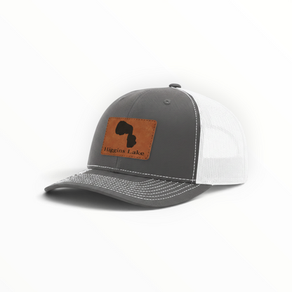 Trucker hat with brown Higgins Lake patch, dark gray front and white mesh back.
