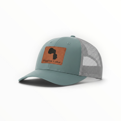 Trucker hat with brown Higgins Lake patch, teal front and gray mesh back.