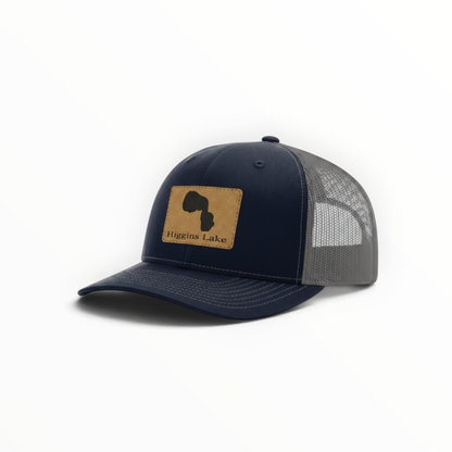 Navy trucker hat with Higgins Lake patch and gray mesh back, curved brim