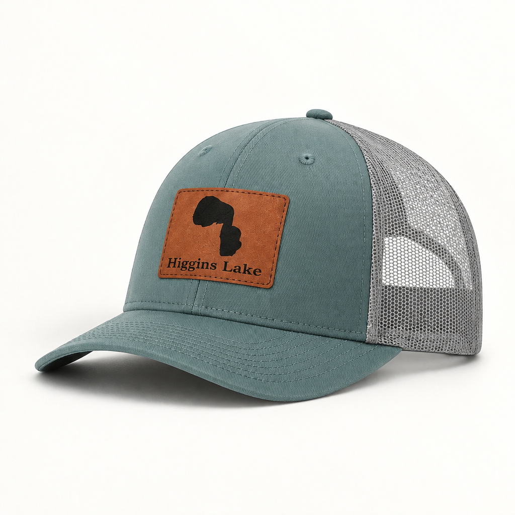 Teal trucker hat with gray mesh back and square tan leather-look patch on front