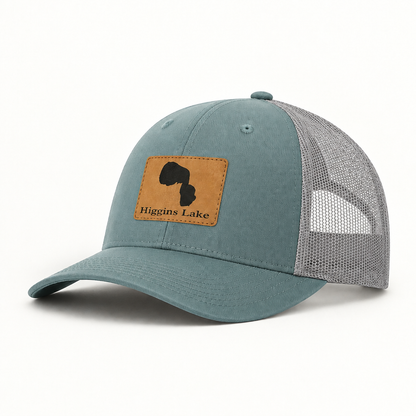 Teal trucker hat with gray mesh back and tan patch featuring a black state silhouette