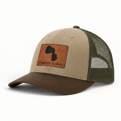 Beige trucker hat with olive mesh back and brown leather-look patch on front