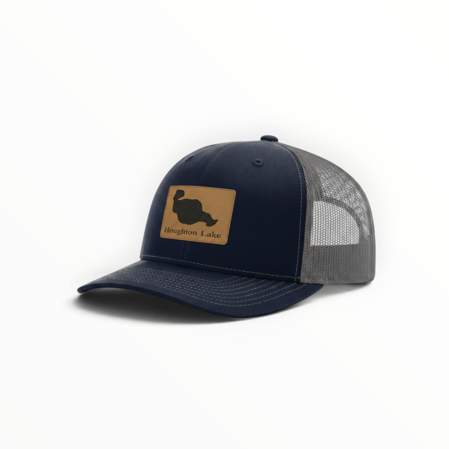 Trucker hat in navy with tan Houghton Lake patch and gray mesh back