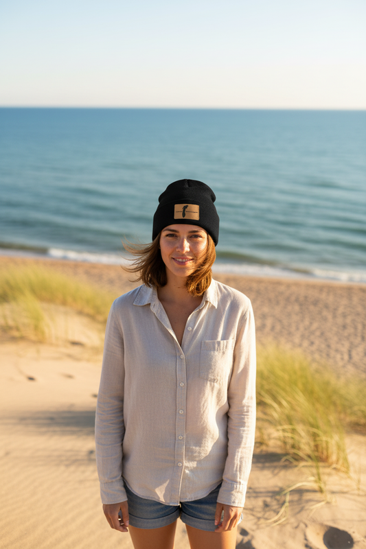 Lake Michigan leatherette patch beanie worn by model on Great Lakes sandy shoreline – Keeko Designs
