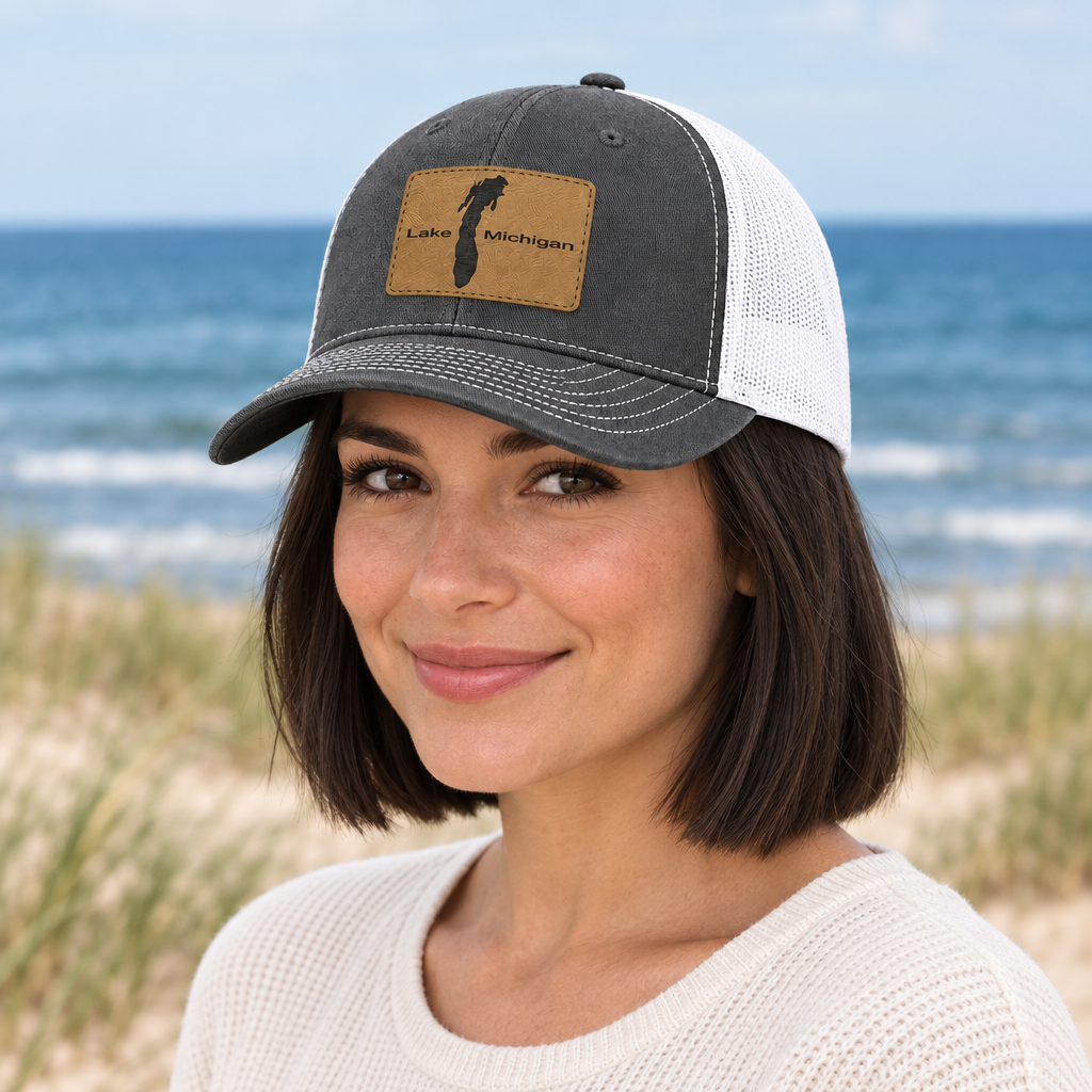 Dark gray trucker hat with white mesh back, tan patch reading "Lake Michigan".