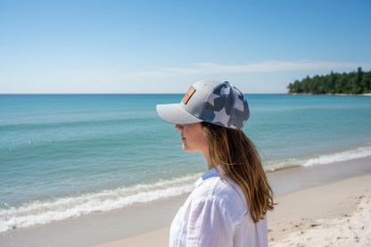 Gray trucker hat with camo star-pattern panels and curved brim