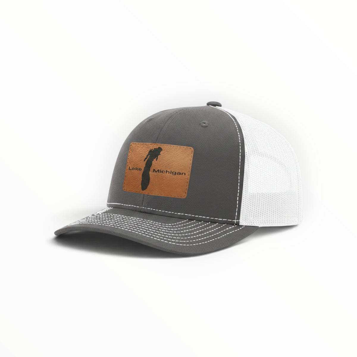 Light gray trucker hat with tan patch and white mesh back, stitched crown